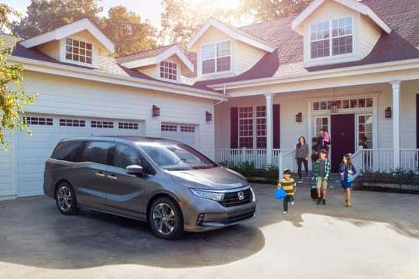 A family with a new vehicle in their driveway